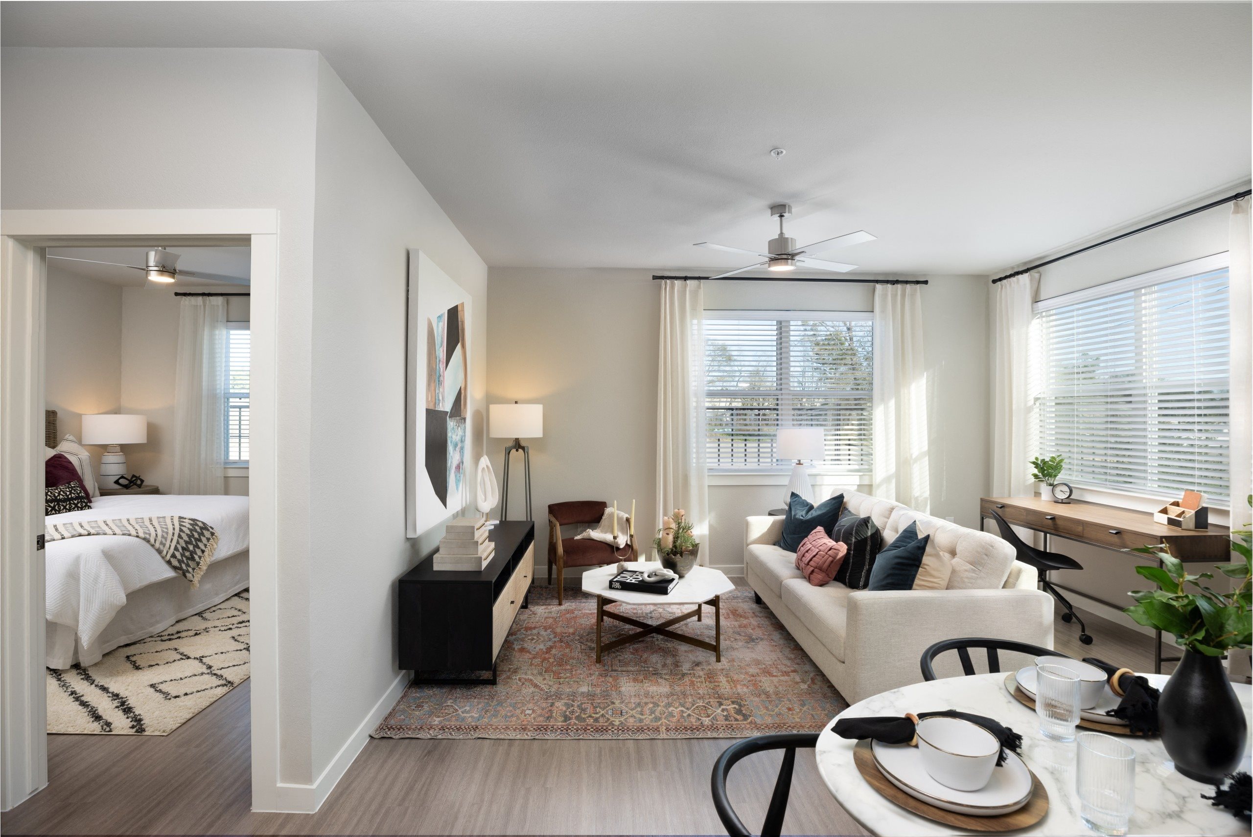 a living room with a couch and a table     and a bedroom